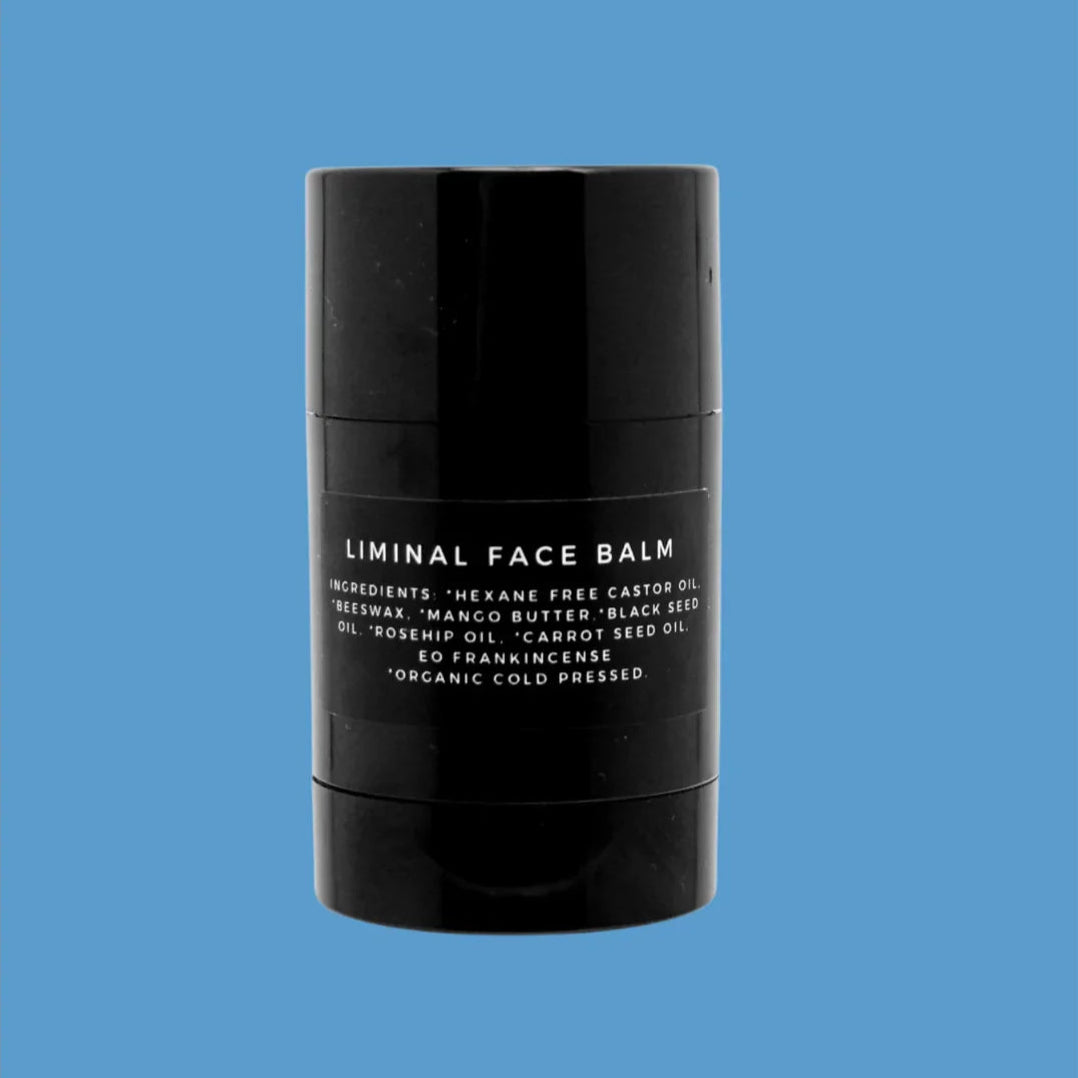 Black face balm container with white text on a blue background