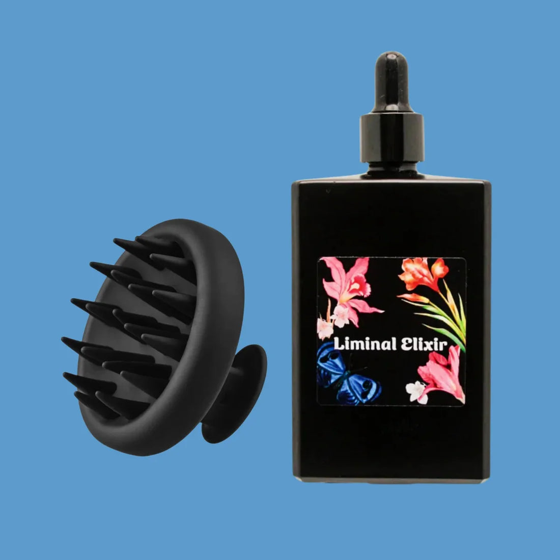 Hair Ritual Bundle with oil bottle and scalp massager on blue background