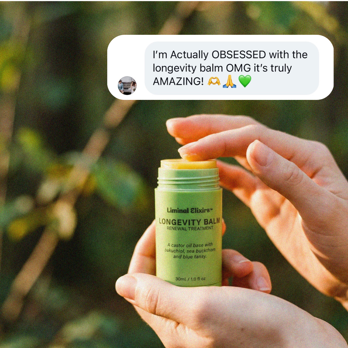 Person holding Liminal Longevity Balm with message text expressing love for the product against a blurred natural background