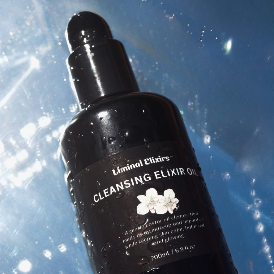 Black bottle of Liminal Elixirs Cleansing Elixir Oil on a blue background