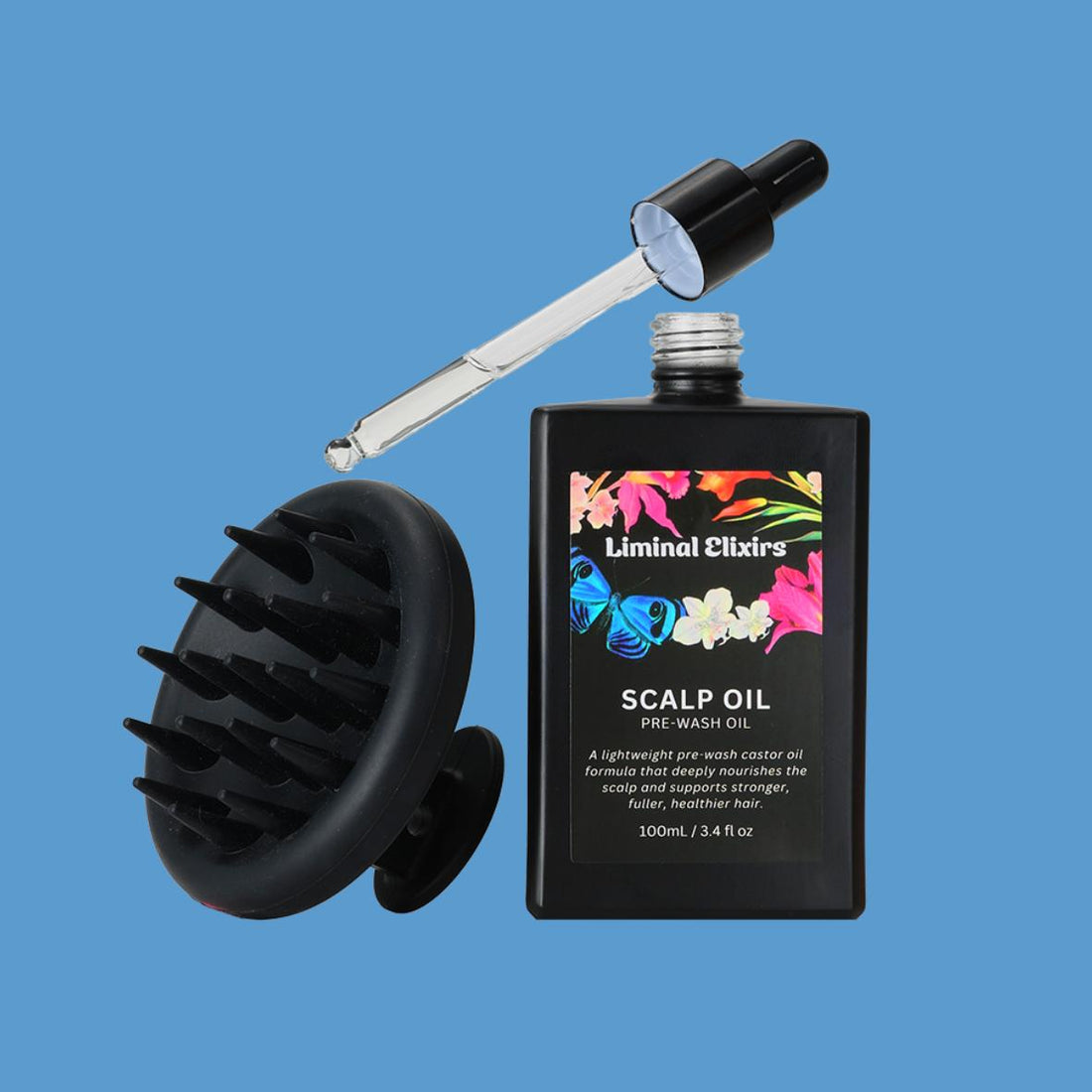 Liminal Elixirs scalp oil bottle with black scalp massager on a blue background