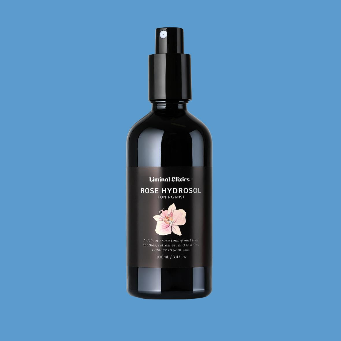 Black bottle of Liminal Elixirs Rose Hydrosol on a blue background