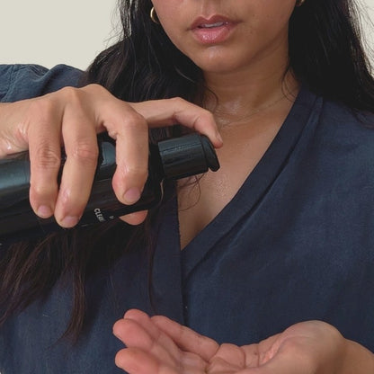 Woman applying 2-3 drops of cleansing oil during Liminal cleansing ritual